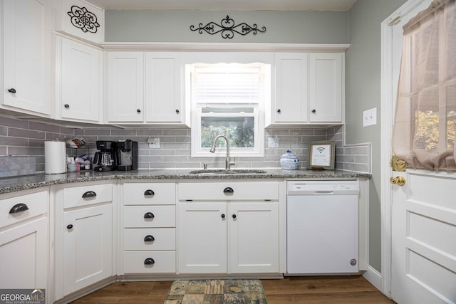 kitchen with backsplash, white cabinetry, sink, and white dishwasher