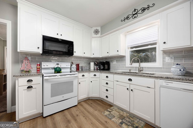 kitchen with decorative backsplash, white appliances, sink, light hardwood / wood-style flooring, and white cabinetry