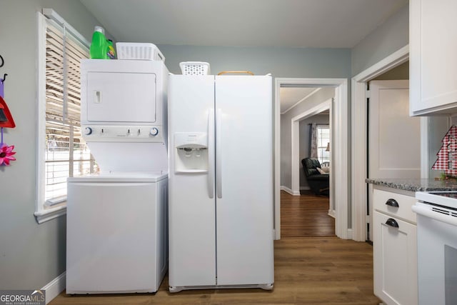 laundry room with wood-type flooring and stacked washer and dryer