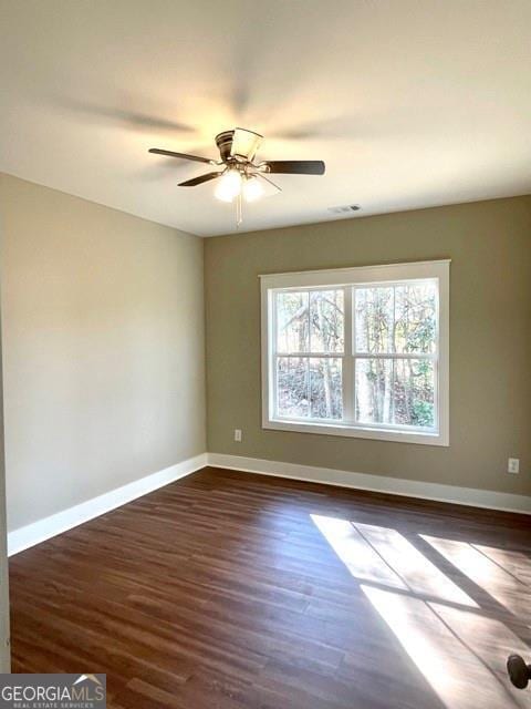 spare room featuring ceiling fan and dark hardwood / wood-style flooring