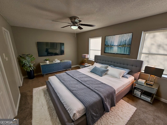 bedroom featuring carpet flooring, a textured ceiling, a ceiling fan, and baseboards