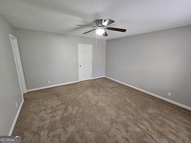 carpeted empty room with baseboards, a textured ceiling, and a ceiling fan