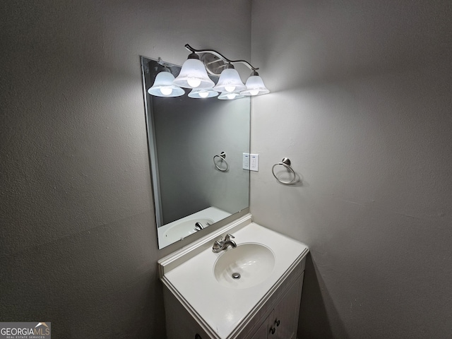 bathroom with a chandelier and vanity