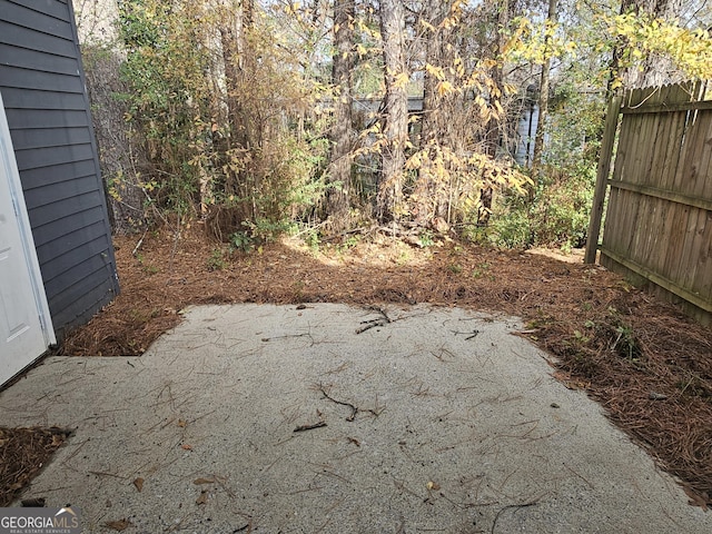 view of yard featuring a patio and fence