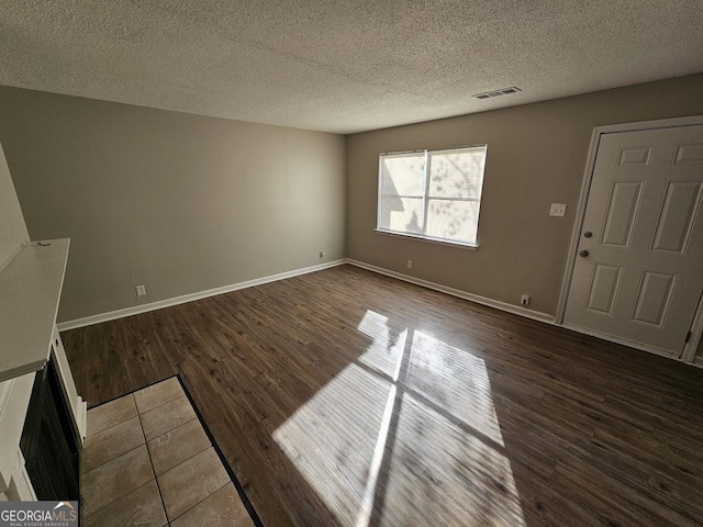 entryway featuring hardwood / wood-style flooring and a textured ceiling