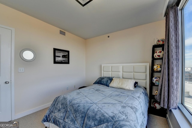 bedroom with light colored carpet