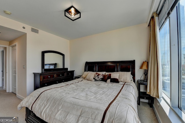 carpeted bedroom featuring multiple windows