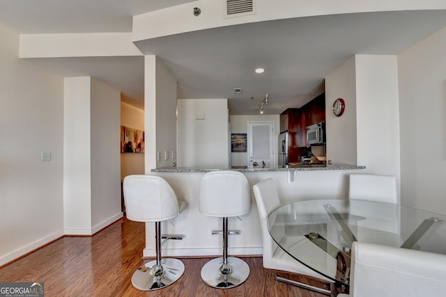 dining area featuring dark wood-type flooring