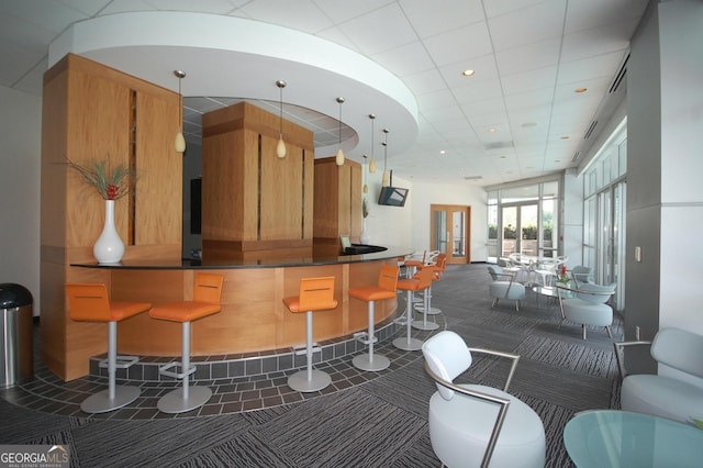 bar featuring french doors and dark carpet