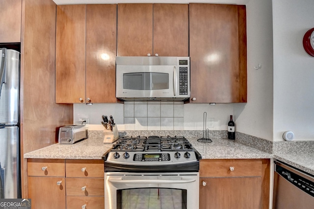 kitchen featuring light stone counters and stainless steel appliances