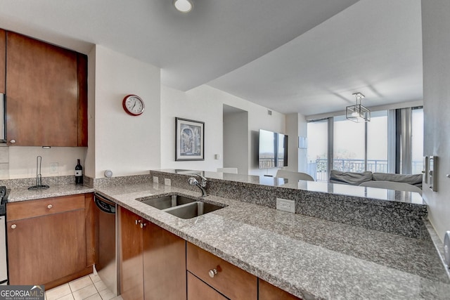 kitchen featuring light stone countertops, sink, dishwasher, kitchen peninsula, and light tile patterned floors