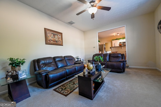 living room featuring carpet flooring and ceiling fan