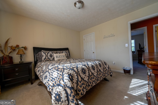 carpeted bedroom with a textured ceiling