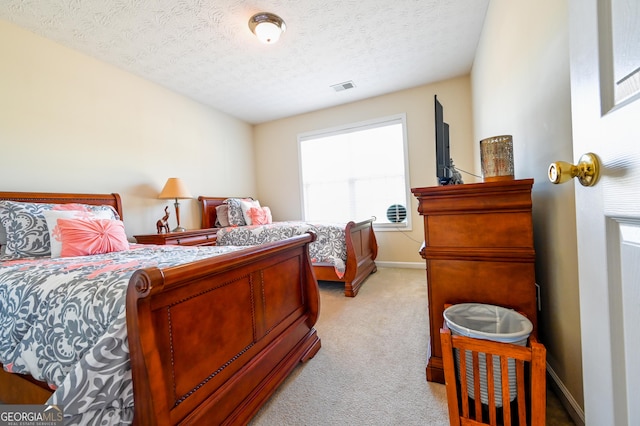 carpeted bedroom featuring a textured ceiling