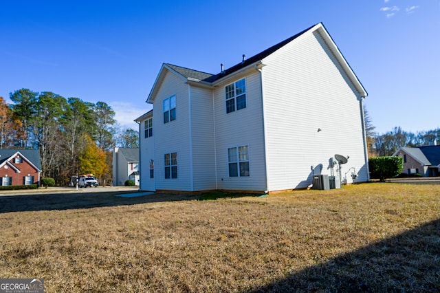 rear view of house with a yard