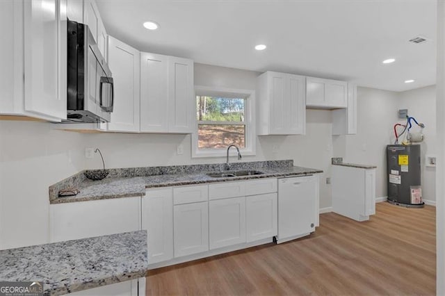 kitchen with sink, electric water heater, white dishwasher, white cabinets, and light wood-type flooring