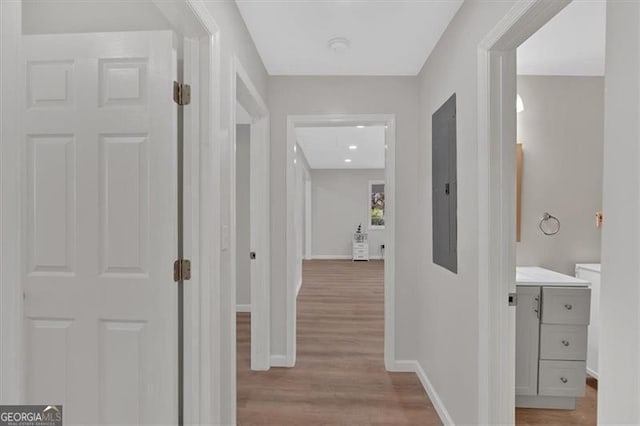 hallway with light hardwood / wood-style floors