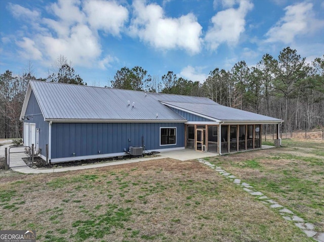 back of property with a lawn and cooling unit