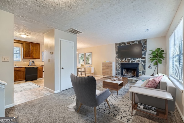 living room featuring a stone fireplace, light carpet, and a textured ceiling