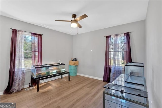 interior space with ceiling fan and hardwood / wood-style flooring