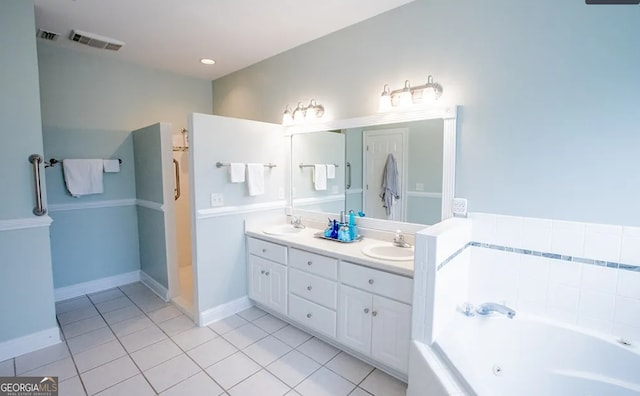 bathroom with tile patterned flooring, vanity, and a bathtub