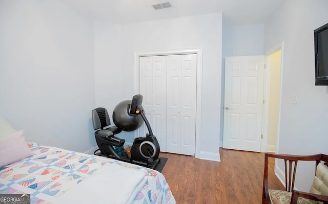 bedroom featuring hardwood / wood-style floors and a closet