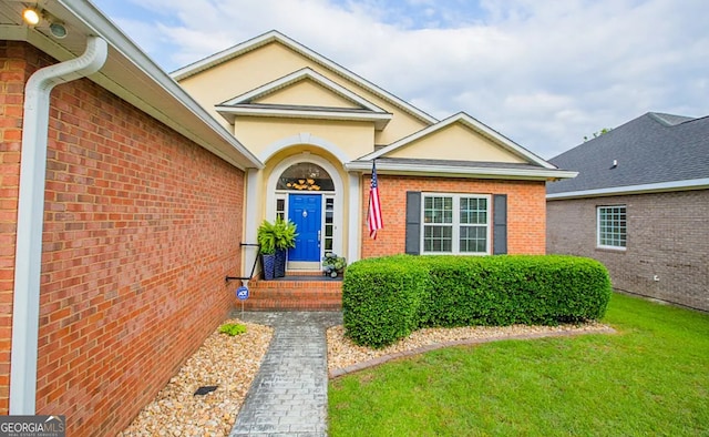 doorway to property featuring a yard