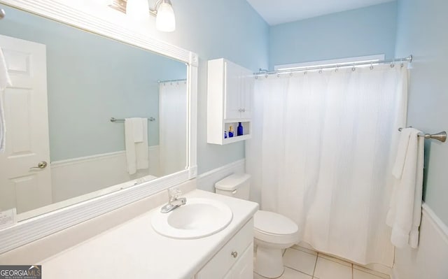 bathroom with tile patterned floors, vanity, toilet, and a shower with curtain