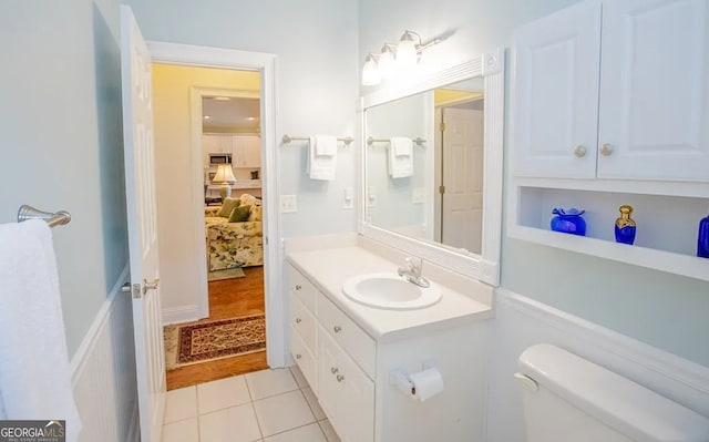 bathroom with toilet, vanity, and hardwood / wood-style flooring