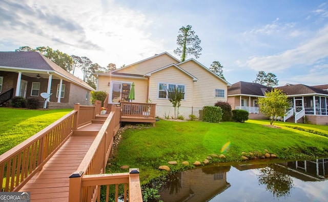 back of property with a yard, ceiling fan, and a sunroom