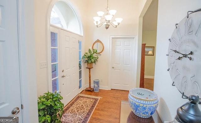 entryway with a chandelier and light hardwood / wood-style floors