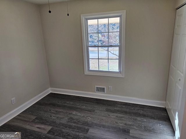 spare room featuring dark hardwood / wood-style flooring