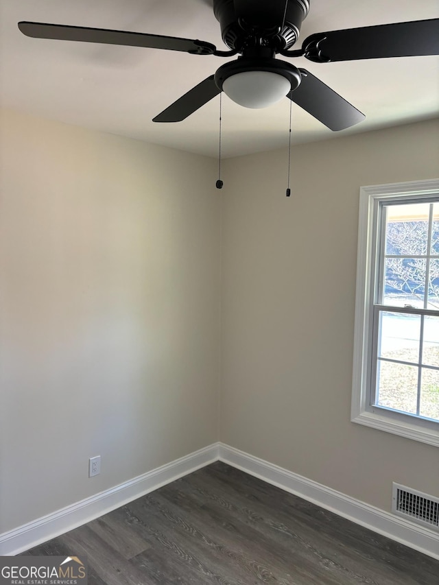 spare room with dark hardwood / wood-style flooring