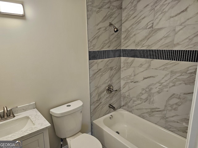 full bathroom featuring vanity, tiled shower / bath combo, and toilet