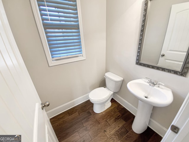 bathroom with toilet and hardwood / wood-style flooring