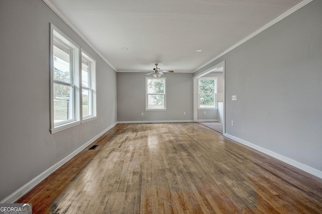 unfurnished room featuring ceiling fan, wood-type flooring, and crown molding