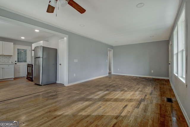 unfurnished living room featuring ceiling fan, light hardwood / wood-style flooring, and ornamental molding