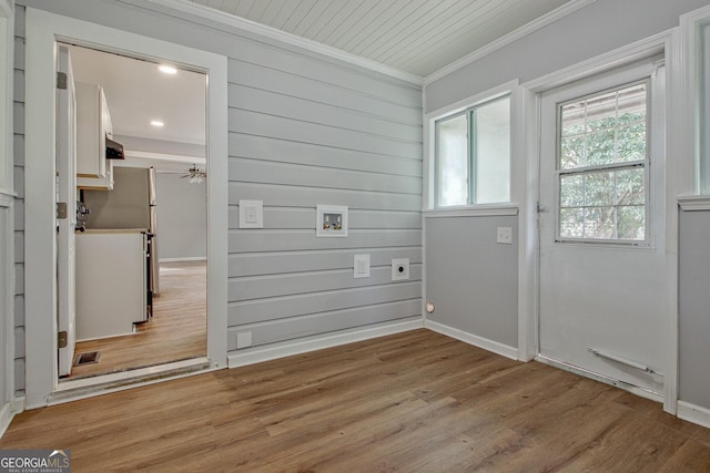 doorway with wood-type flooring, ceiling fan, and ornamental molding