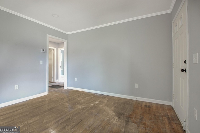 unfurnished room featuring ornamental molding and dark wood-type flooring