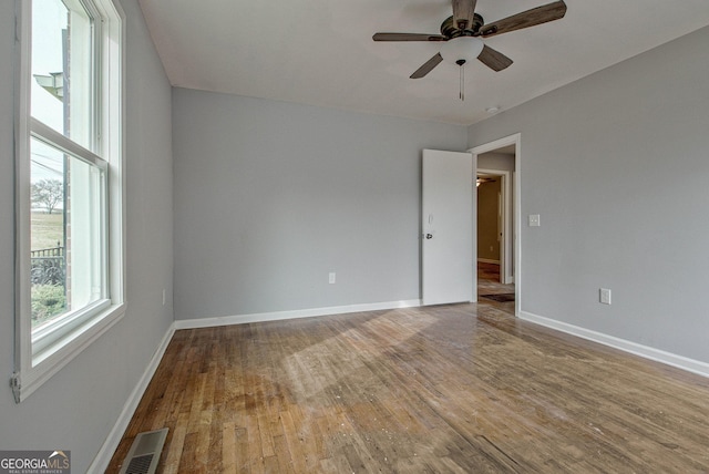 spare room featuring hardwood / wood-style floors and ceiling fan