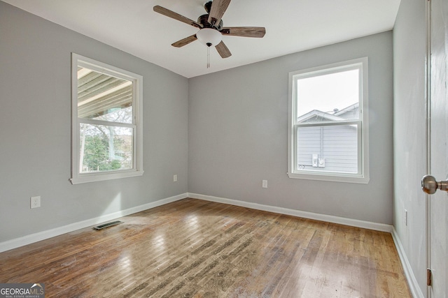 unfurnished room with hardwood / wood-style floors and ceiling fan