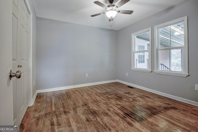 unfurnished room featuring hardwood / wood-style floors and ceiling fan