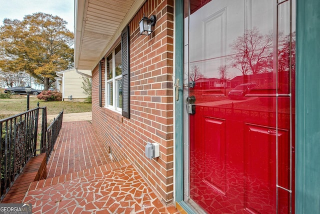 view of exterior entry featuring covered porch