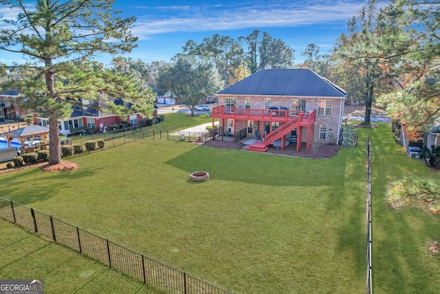 view of yard with a wooden deck, a patio, and an outdoor fire pit