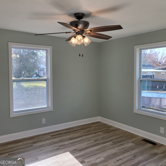 spare room featuring ceiling fan and light hardwood / wood-style floors