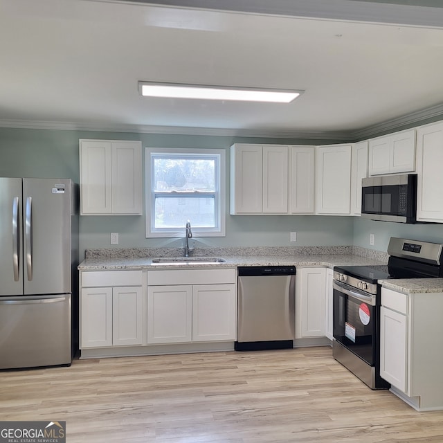 kitchen with white cabinets, stainless steel appliances, and sink