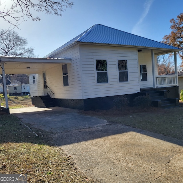 view of side of home featuring a carport