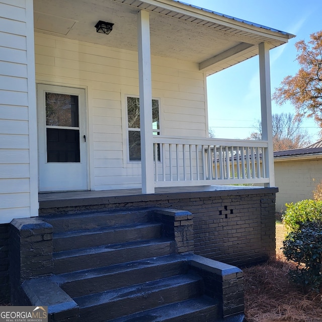 view of exterior entry featuring a porch