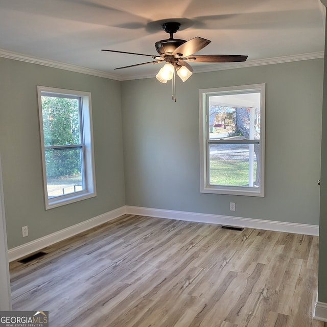 empty room featuring ceiling fan, ornamental molding, and light wood-type flooring