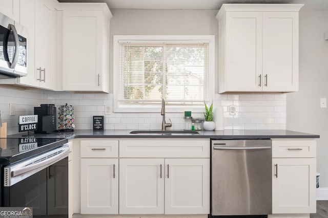 kitchen featuring sink, stainless steel appliances, and white cabinets